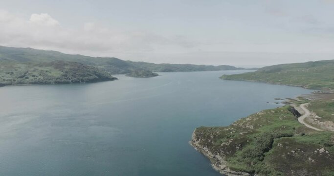 Wide drone shot showing the estuary and surroundings of the Kylesku Bridge along Scotland northcoast 500 route