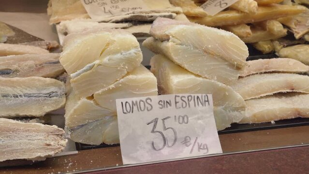 Dried salted cod loins on a counter of a central market (Mercado Central) stall in Valencia, Spain.