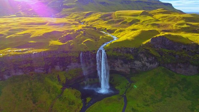 Drone view of Seljalandfoss waterfall Iceland with beautiful rainbows and shining lights