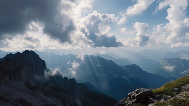 Marvel at the dynamic spectacle of clouds rolling over the mountains, their billowy forms creating a dramatic interplay of light and shadow. Generated by AI.