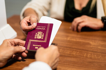 senior woman handing over passport at airport