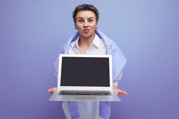 european young brunette lady with short haircut holding a laptop for work in her hands