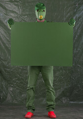 green alien with green poster