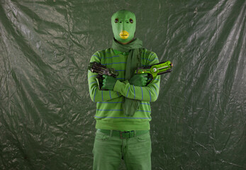 green alien with space weapon