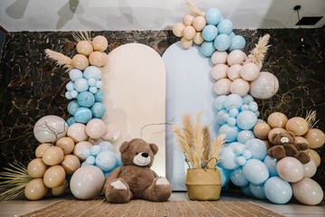 Photo-wall decoration space or place with beige, brown, blue balloons. Celebration baptism concept....