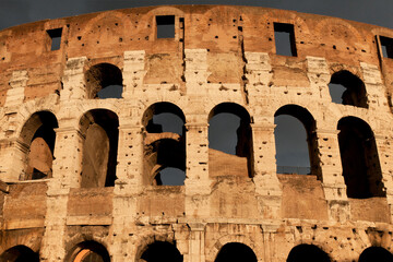Obraz premium Rome, Lazio, Italy, Europe - Colosseum, elliptical Flavian Amphitheatre in city center, the largest ancient amphitheatre ever built in the world, dark stormy clouds, UNESCO World Heritage
