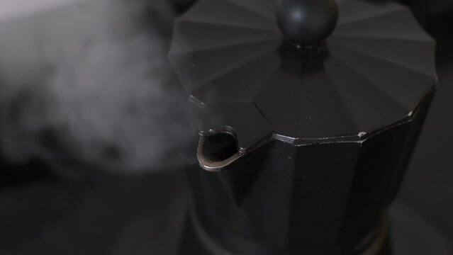 steam coming out of moka pot, freshly made coffee in a traditional way with an italian coffee maker

