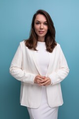 portrait of a cute brunette woman in a white dress with pleasant features