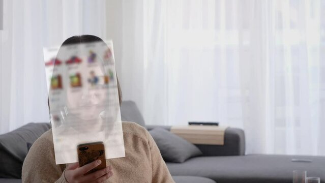 Asian woman scrolling social media app in smartphone with lifestyle content displaying in front of her. Portrait of Asian lady at home scrolling social media app. Technology, Attention span concept