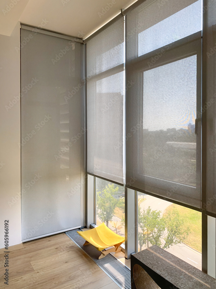 Aufkleber roller blinds on the windows in the interior. automatic solar shades on full height windows. motoriz