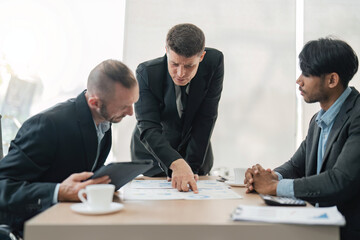 Business people, conversation and laptop data with planning and strategy in office. Training, communication and online chart with corporate paperwork and working on a teamwork project with diversity