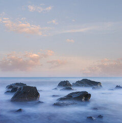 sea coast with stones at the early morning, long exposure sea landscape