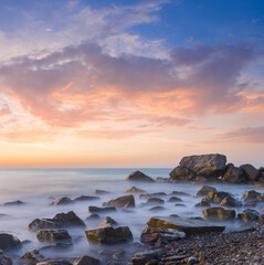 sea coast with stones at the early morning, long exposure sea landscape