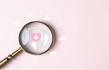 Health insurance concept. people hand holding magnifier focus to plus sign and protection icon....