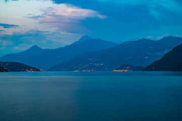Fototapeta na wymiar Panorama on Lake Como, with the villages of Tremezzina, Bellagio, Varenna and the mountains that overlook them, photographed in the evening. 