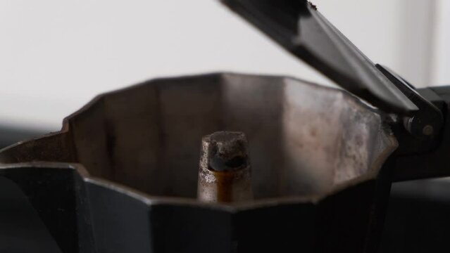 close-up of freshly brewed coffee in a stove, extraction from the moka pot little by little in
