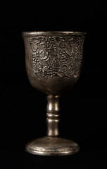 Antique silver royal goblet with grape engraving.