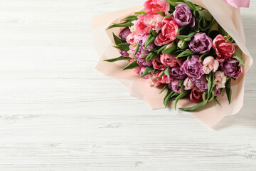 Bouquet of beautiful tulips on white wooden table, closeup. Space for text