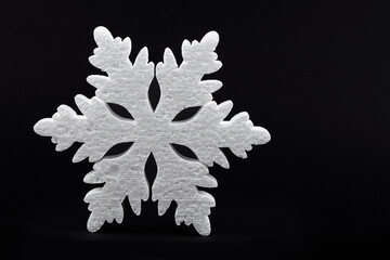 Festive Christmas background. black background large white snowflake.