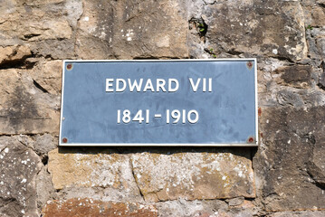 Metal Sign 'Edward VII 1841-1910' on Old Rough Stone Wall