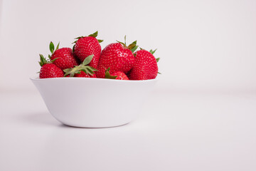 Ceramic bowl filled with strawberries. Healthy lifestyle. Close up photo of strawberries 