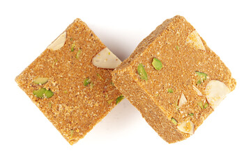 Two pieces of Homemade Indian mithai (dessert) Besan Gajak Barfi. Made of Til, Desi Ghee, jaggery, and Dry Fruits. Top view.