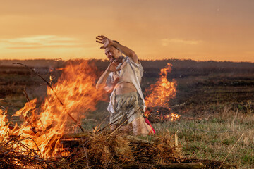 young guy crying in fire in burnt clothes asking God for help, war, house destruction, human...