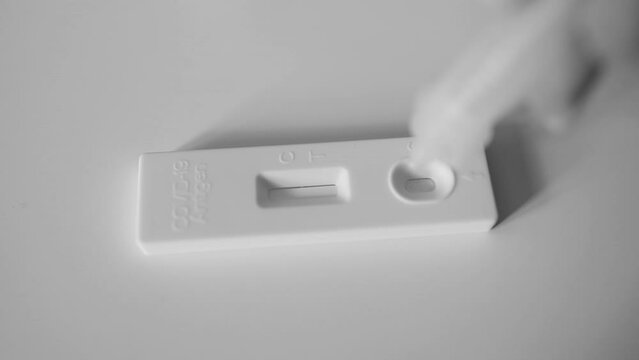 A patient with Covid-19 did an express test at home, the result is positive. Covid-19 test kit for detecting IgM IgG antibodies and immunity in 15 minutes. High quality FullHD footage