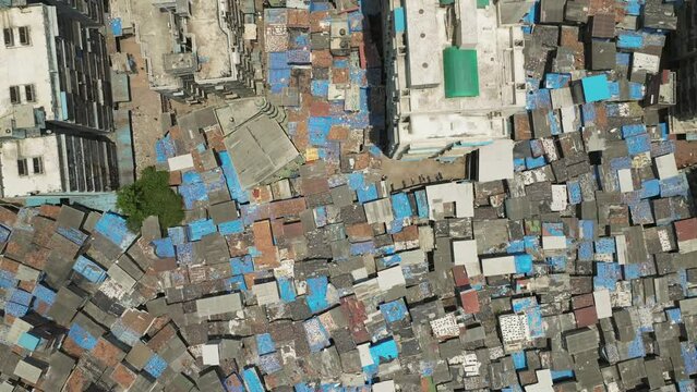 Aerial top down view over Dharavi Slum rooftops, over populated location Mumbai. India