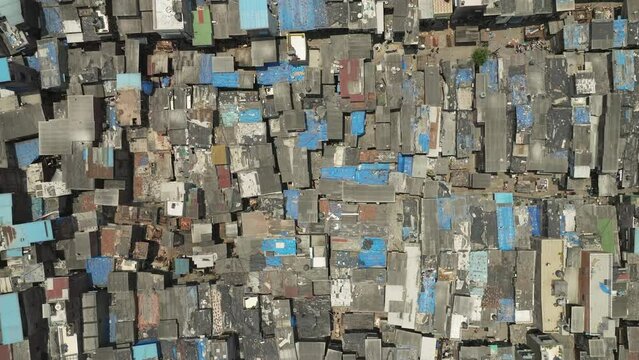 Drone flyover on of the largest slum in the world, topdown view of Dharavi slum complex. Mumbai