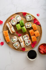 Fototapeta na wymiar Overhead view of sushi rolls set and soy sauce