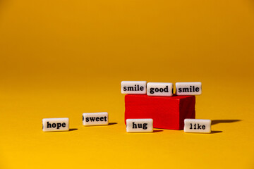 Obraz premium positive words on the square and next to it, yellow background, creative concept 