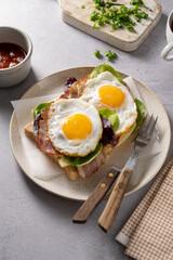 Breakfast food, fried eggs with bacon on toast. 