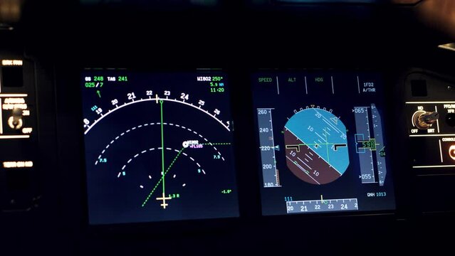 Closeup of dashboard plane panel with pointers for a flight simulator with illuminated buttons