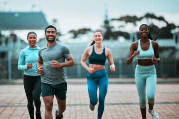 Portrait, running and group on a track, exercise and workout goal with motivation, happiness and race. Face, man or women outdoor, run or race for training, fitness and health with wellness and smile