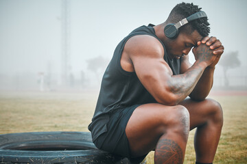 Music, fitness and thinking with black man in park for exercise, strong and motivation. Streaming,...