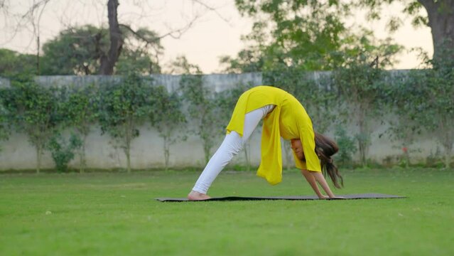 Indian girl doing surya namaskar yoga pose
