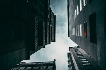 Low angle shot of modern black buildings against a cloudy sky in Montreal, Ontario, Canada