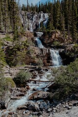 Vertical shot of the waterfall in the Jasper National Park under a blue sky in Canada
