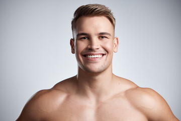 Portrait of happy man, fitness and muscle on studio, background and backdrop of strong power,...