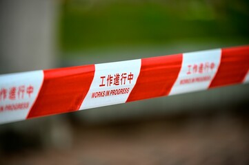 Closeup shot of a red white striped works in progress warning sign