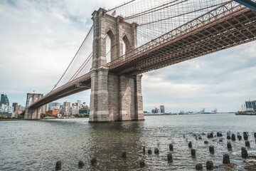 Fototapeta premium Brooklyn Bridge with city buildings in the background. New York, USA.