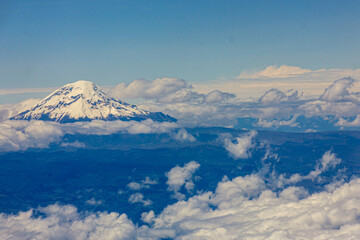 Snowy peak of Chimborazo, the tallest volcano in Ecuador, in clouds, from the air