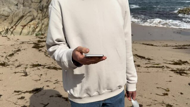 Close up view of male hands using smartphone scrolling, browsing, surfing internet, social media browsing slow motion