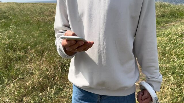 Close up view of male hands using smartphone scrolling, browsing, surfing internet, social media browsing slow motion