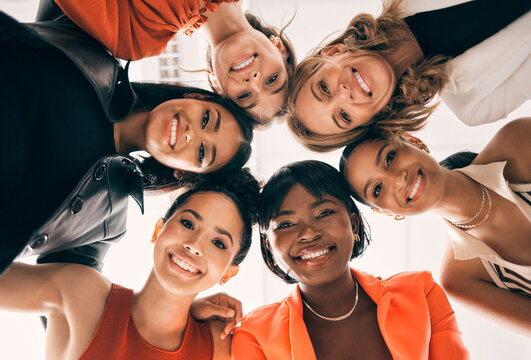 Diversity, circle and low angle portrait of businesswomen in a huddle at a team building meeting. Happy, confidence and group of professional female employees in collaboration bonding in the office.