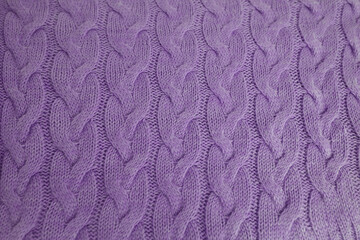 beautiful knitted braid pattern of light lilac wool yarn, knitted texture, concept warm things for cold weather, knitting as a hobby for women, needlework, fashion clothes