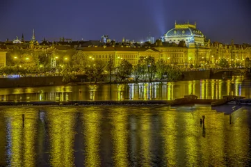 Deurstickers Night photo of the shore of river Vltava and National Theatre in Prague,Czech Republic,Europe,Central Europe  © kstipek
