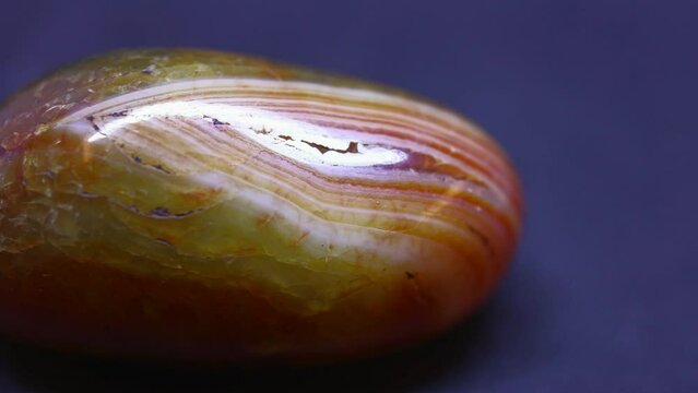 Macro shot of polished Jadeite mineral from China on purple background