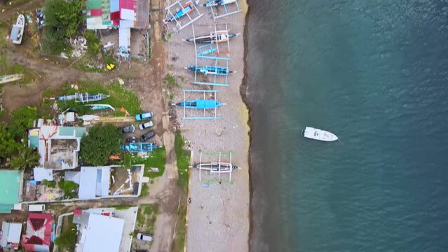 Drone view of moored boats on the edge of the shore in Anilao, Batangas, Philippines